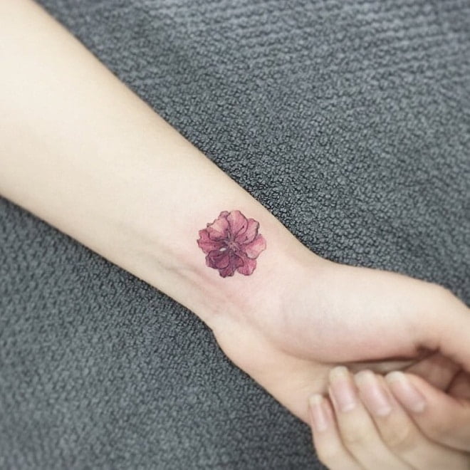 Bông hoa mẫu đơn nhỏ khoe sắc trên tay cô gái